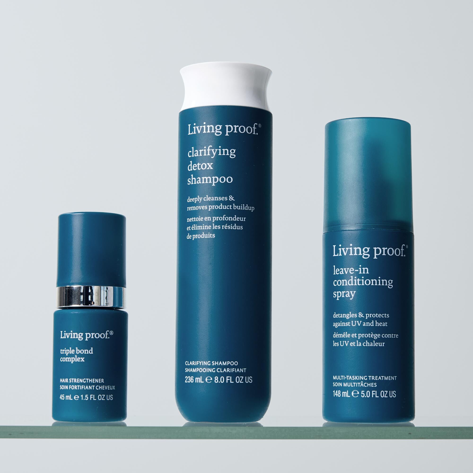 The blue Leave-In Conditioning Spray stands upright against a light blue background, highlighting lasting detangling and weightless conditioning as your wash day essential.
