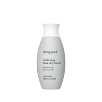 A grey bottle of Full Thickening Blow-Dry Cream (109 ml/3.7 fl oz) with a white cap and black text delivers thicker-looking hair, adds body, and provides heat protection while styling.