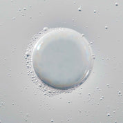 A large, translucent bubble surrounded by smaller bubbles on a smooth, light gray surface evokes the effect of Full Volume & Root-Lifting Spray, which delivers all-day fullness and weightless lift.