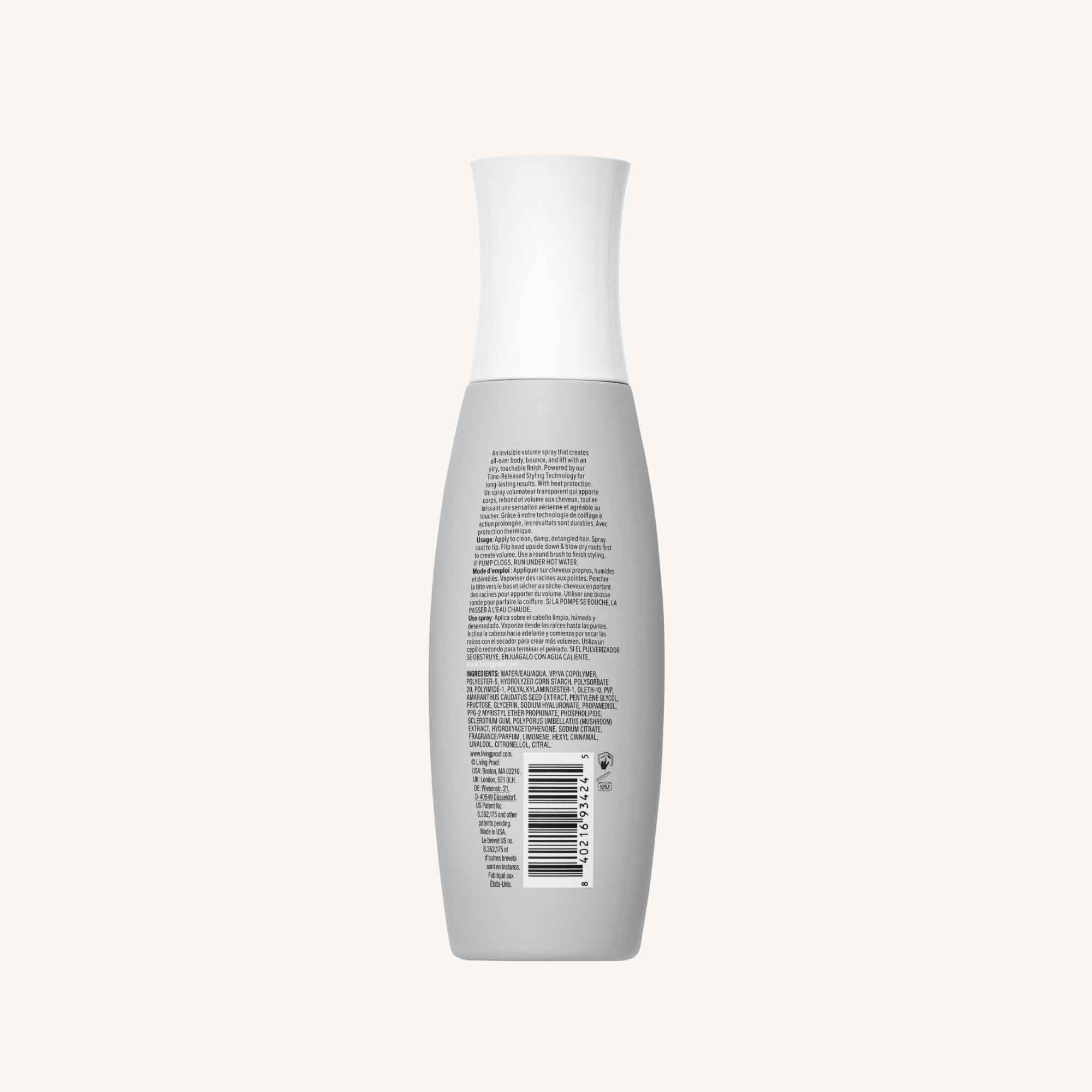 A gray bottle with a white cap, shown from the back with small text and a barcode, sits against an off-white background—a sleek package for Full Volume & Root-Lifting Spray that delivers all-day fullness.