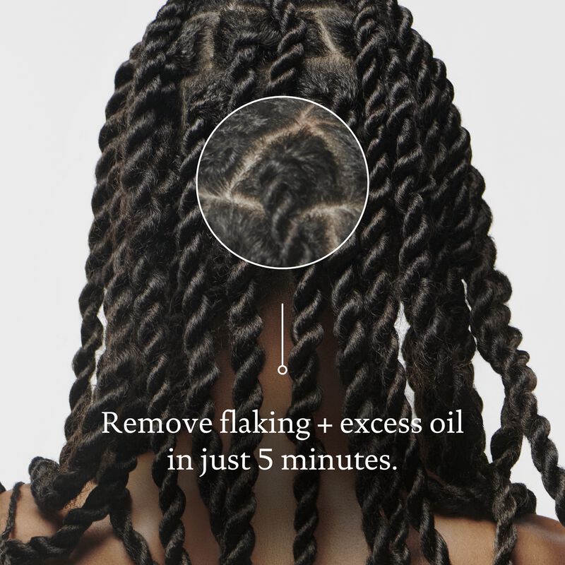 Close-up of a person’s scalp with tidy, twisted braids. A circular zoom highlights clean hair partings. Text: Scalp Care Exfoliator removes dry scalp flakes and excess oil in just 5 minutes—ideal as a pre-shampoo treatment.