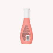 A pink Curl Enhancer bottle with a white cap, shown from the back with small text and a barcode on the label, ideal for frizz protection as a conditioning styler, set against a plain light background.