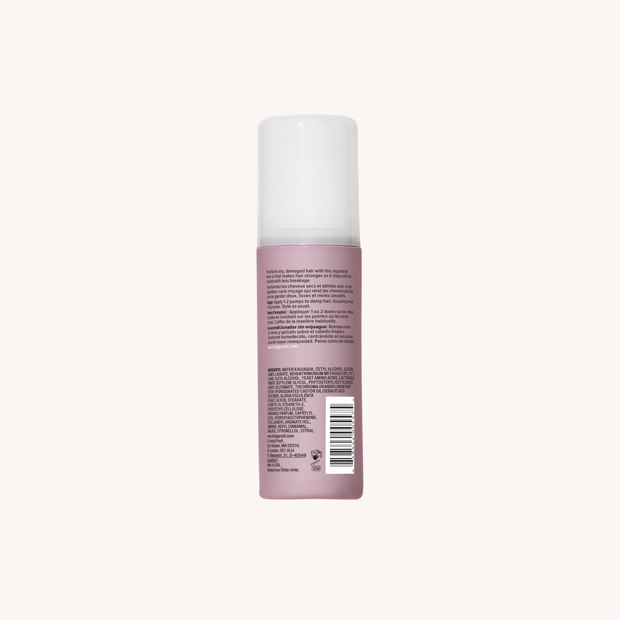 A pink bottle of Restore Repair Leave-In conditioner with a white cap stands upright against a plain light background. The back label displays text, a barcode, and product details about strengthening hair and preventing split ends.
