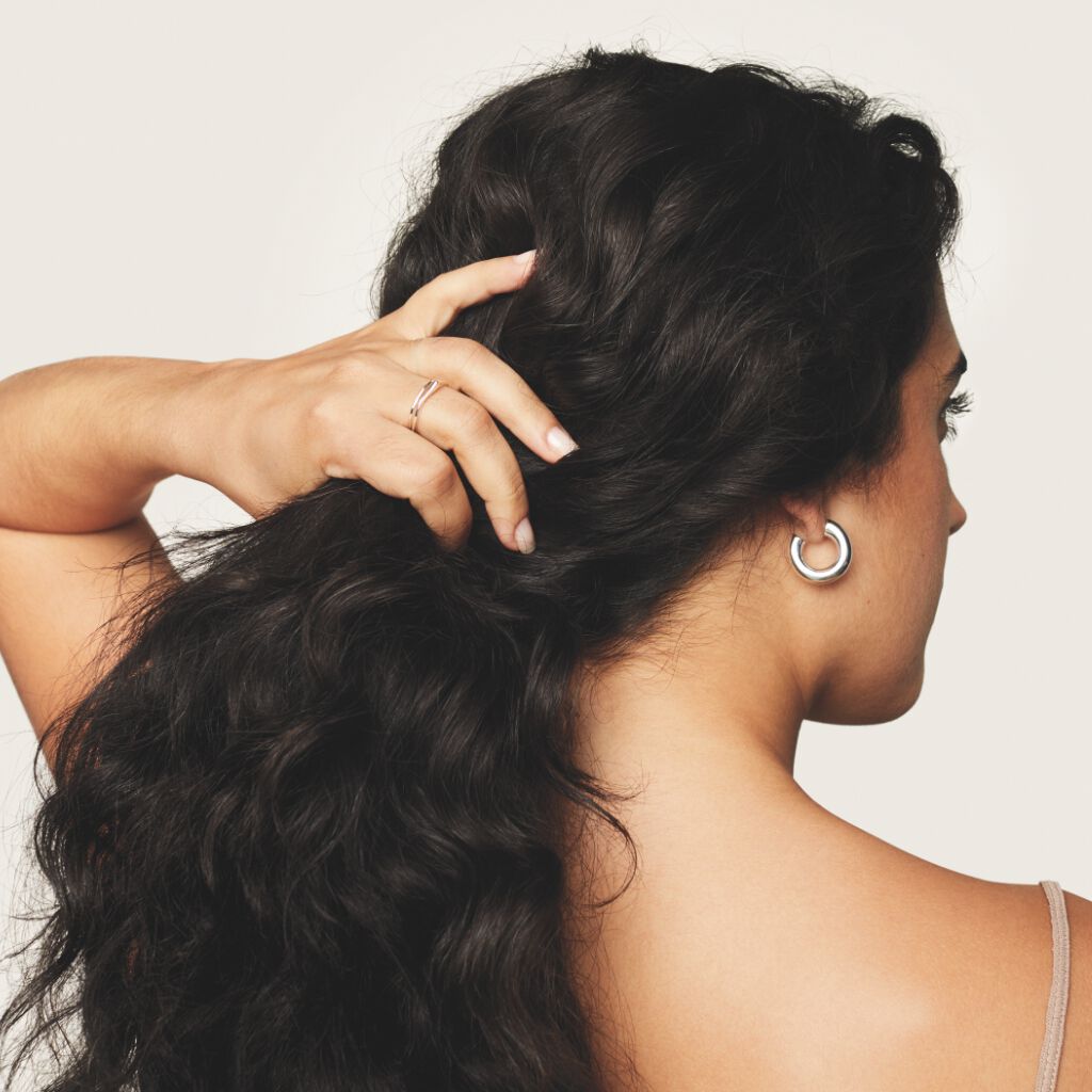 woman holding her dark brown hair