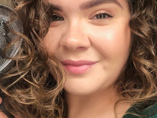 woman with curly hair smiling