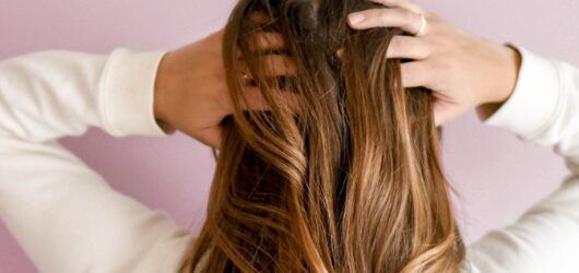 woman combing her fingers through her hair