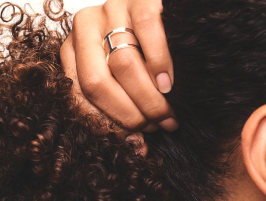 woman holding her curly hair