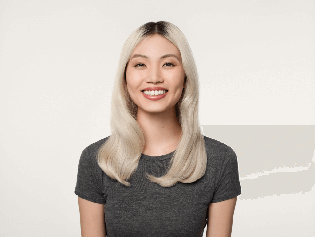 happy girl with styled ashy blond hair in a grey t-shirt