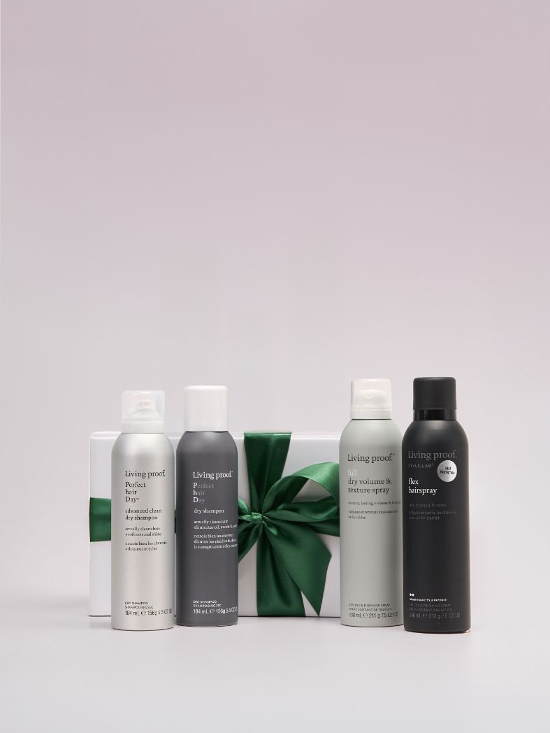 Set of Living Proof hair care products on a light gray background