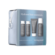 The Perfect hair Day™ Hydrated Hair Essentials set includes four gray bottles—shampoo, conditioner, styling cream, and dry shampoo—for silicone-free hair, all in a light blue zippered bag labeled “Hydrated hair essentials.”.