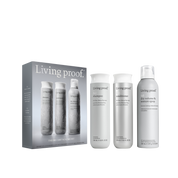 The Instant Volume Set featuring three white bottles—volume shampoo, conditioner, and dry texture spray for fuller hair—displayed next to a gray box showcasing the same products.
