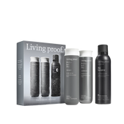 The Hydrate + Hold Set showcases three must-haves: Conditioner, Perfect hair Day Shampoo, and Flex Hairspray. Each bottle—one gray, one white, and one black with bold white lettering—stands upright before the sleek product box.
