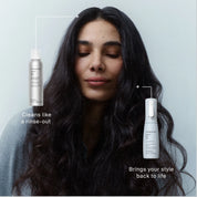 A woman with long, wavy dark hair closes her eyes peacefully against a white background. Text highlights The Style Refresh Set: featuring a dry shampoo that cleans like a rinse-out and a style refresh mist that revives your look.