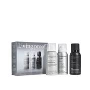 The Travel Essentials Set by Living Proof, featuring three hair products—Dry Volume & Texture Spray, Advanced Clean Dry Shampoo, and shampoo—arranged beside the product box, which showcases images and details about the items.