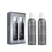 Two gray bottles from The Classic Clean Dry Shampoo Set sit next to their product box, which displays an image of the matching bottles and product details—a perfect holiday set for refreshing your hair on the go.