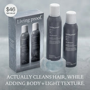 The Classic Clean Dry Shampoo Set: This holiday set includes two bottles of Living Proof Perfect Hair Day Dry Shampoo in elegant packaging, beautifully displayed on a frosted surface. Text on packaging: ACTUALLY CLEANS HAIR, WHILE ADDING BODY + LIGHT TEXTURE. Price: $46 ($66 value).