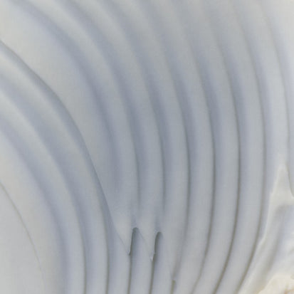 Close-up of a textured white surface with concentric circular patterns