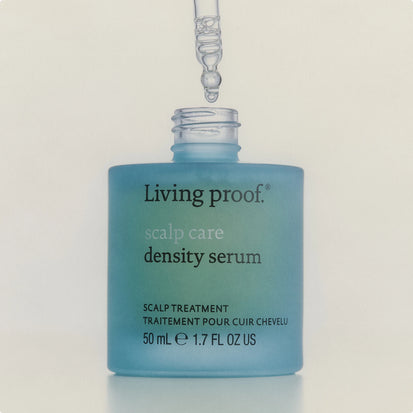 Living Proof scalp care density serum bottle with dropper on a light background