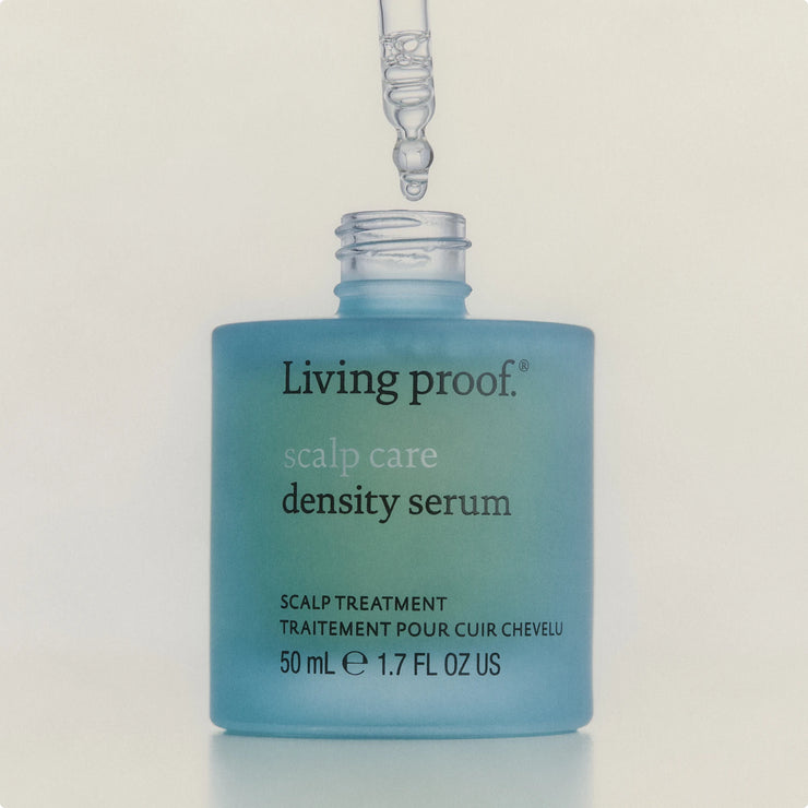 Living Proof scalp care density serum bottle with dropper on a light background