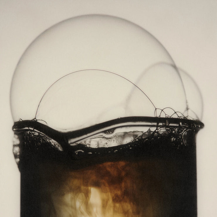 Close-up of an old light bulb with visible filaments and glass.