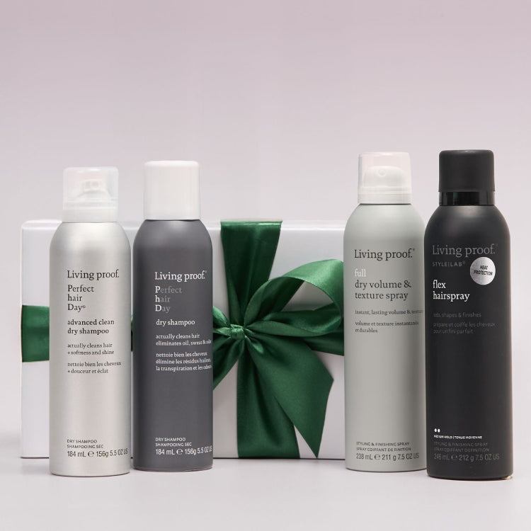 Living Proof hair care products including dry shampoo, dry volume & texture spray, and flex hairspray with a green ribbon in the background.