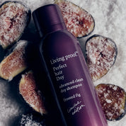 A can of Perfect hair Day™ Frosted Fig Advanced Clean Dry Shampoo is placed among sliced figs dusted with powdered sugar.