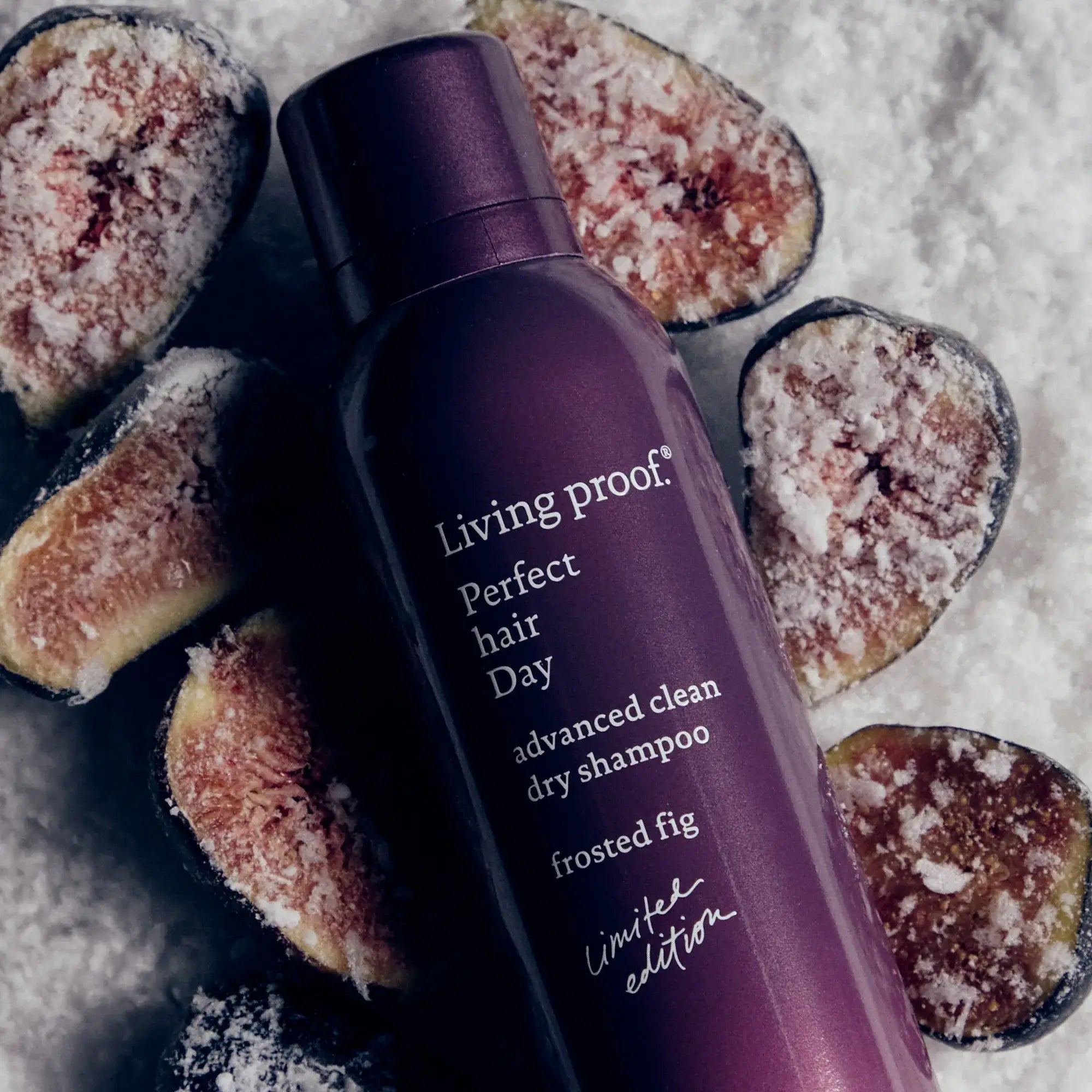 A can of Perfect hair Day™ Frosted Fig Advanced Clean Dry Shampoo is placed among sliced figs dusted with powdered sugar.