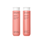 Two bottles of Living Proof curl shampoo and conditioner on a black background