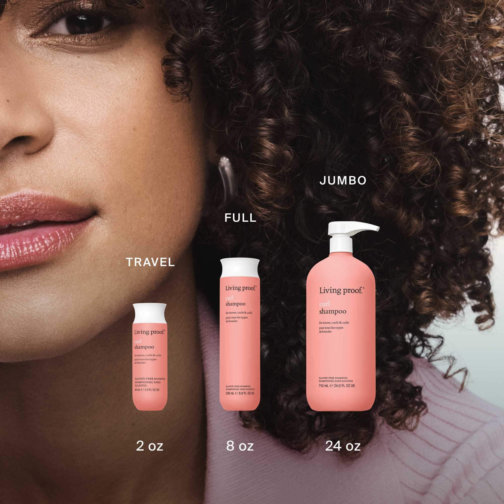 Close-up of a woman with curly hair beside three pink Curl Conditioner bottles in Travel (2 oz), Full (8 oz), and Jumbo (24 oz) sizes—ideal for all curl types and pairing with a hydrating shampoo to help define curls.