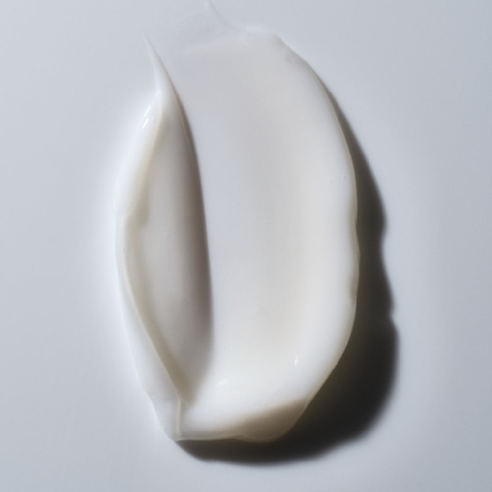 Curl Curly Hair Essentials is a smooth, creamy white product applied to hair for frizz-free curls and added shine, similar in texture to a moisturizing lotion.