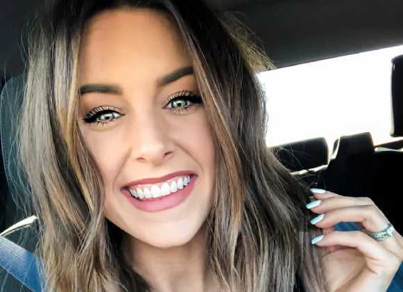 Woman sitting in a car with a blurred background