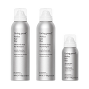 Three silver cans from The Advanced Clean Set, each in a different size with white caps and black text on the front, are arranged upright against a white background. These cans highlight a formula that extends time between washes while leaving your hair feeling as soft as if it were just washed.