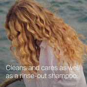 Person with wavy blonde hair by water, text overlay about shampoo.