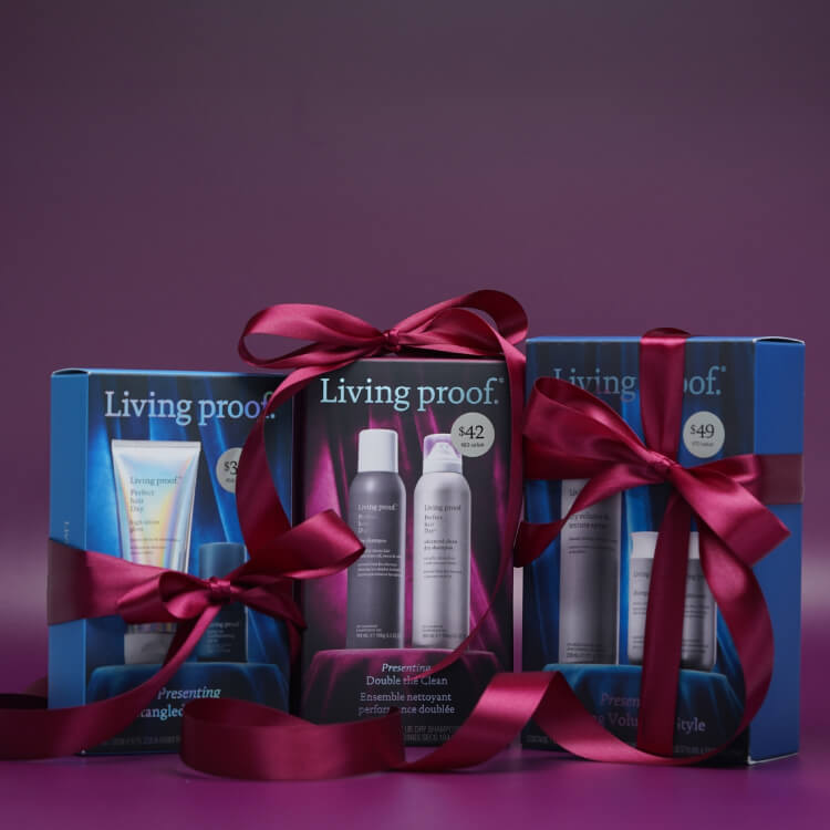 Living Proof product set with red ribbons on a purple background