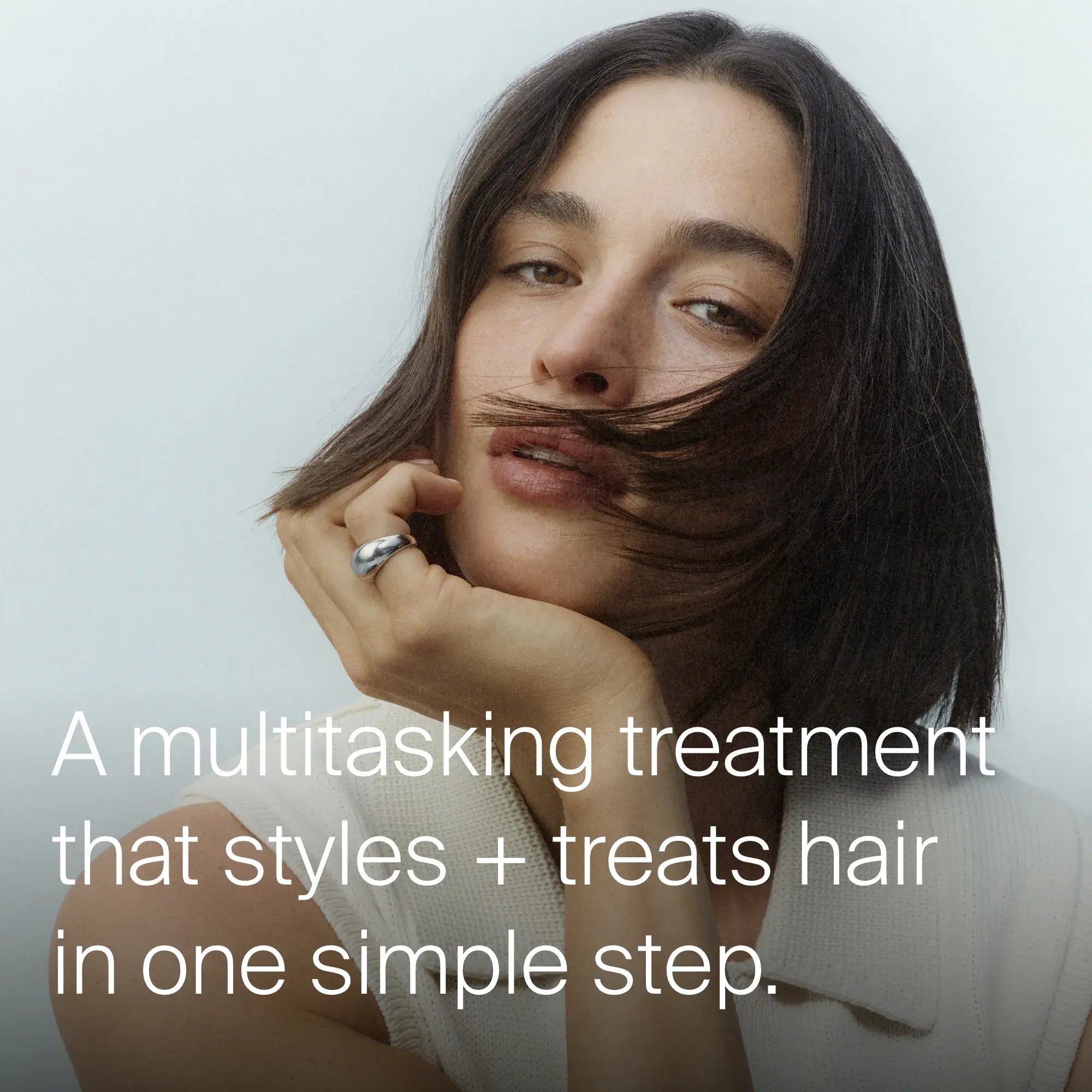 Woman with short dark hair and a tagline "A multitasking treatment that style + treats hair in one simple step"