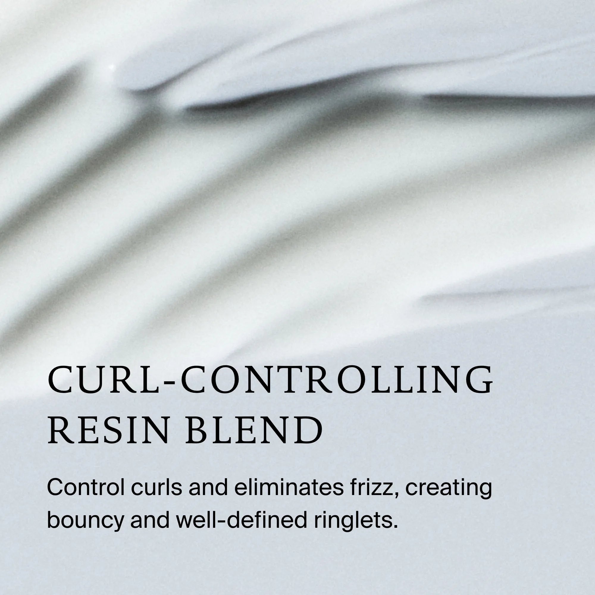 Close-up of Curl Definer’s creamy white texture with smooth waves. Text: “Curl-controlling resin blend defines curls and eliminates frizz, creating bouncy, well-defined ringlets.”.