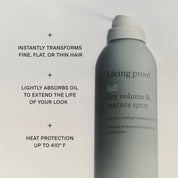 Living Proof dry volume and texture spray bottle with text highlighting features on a light gray background