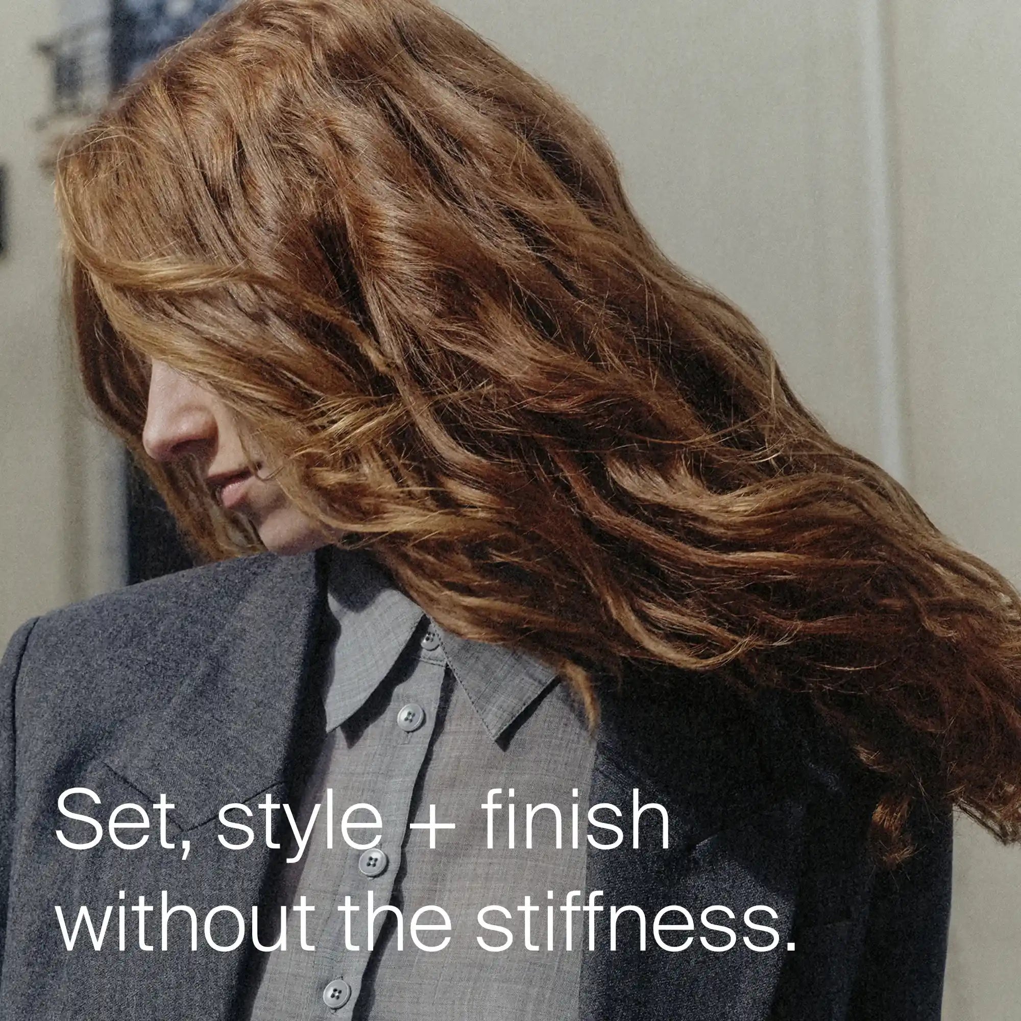 Person with styled hair wearing a gray outfit, with text 'Set, style + finish without the stiffness.'