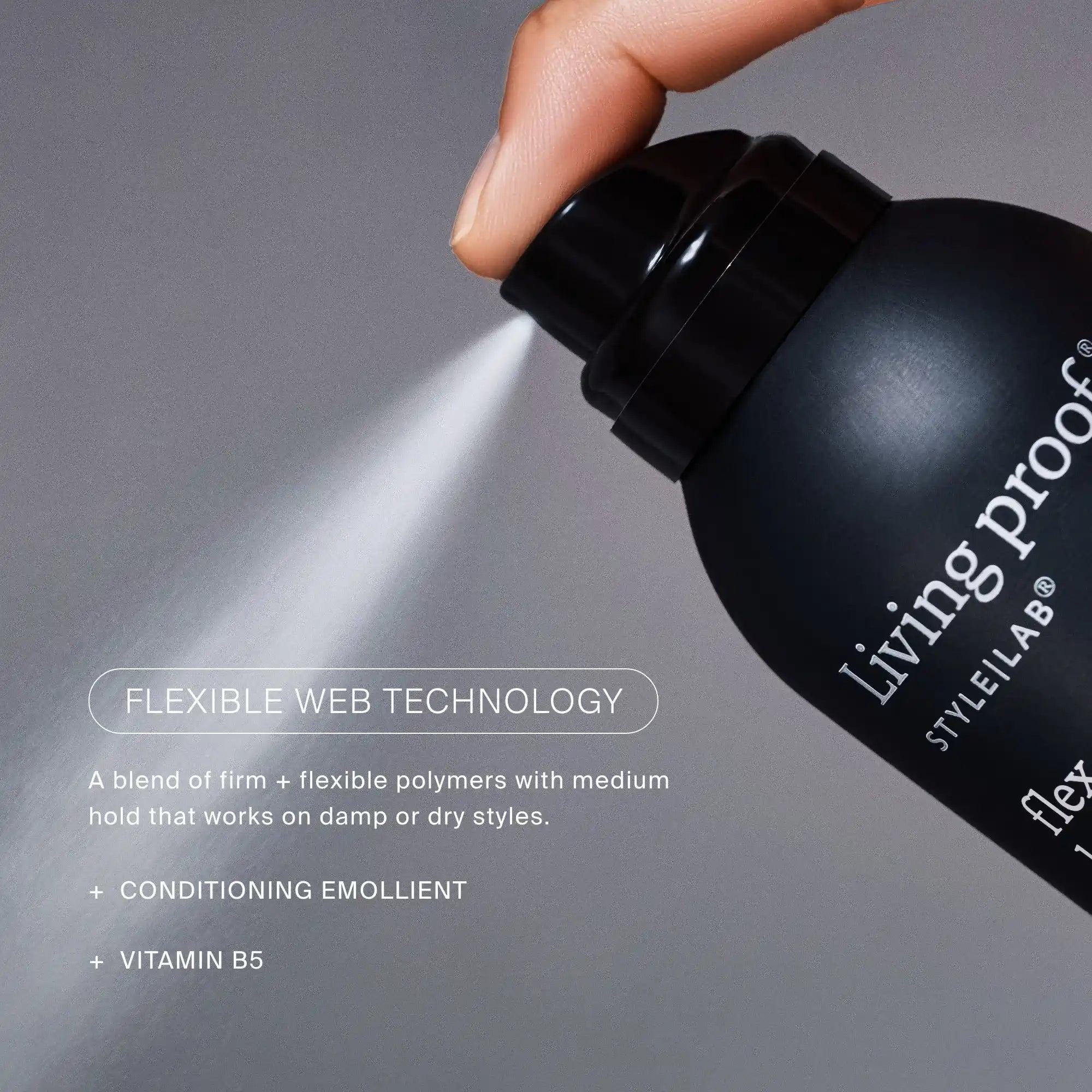 Living Proof hair product being sprayed with a gray background
