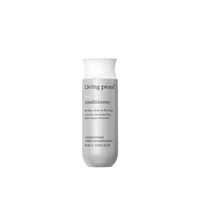 Living Proof hair conditioner bottle on a black background