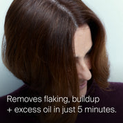 A person with shoulder-length brown hair looks down, revealing a clean scalp. Text: Scalp Care Exfoliator removes flakes, buildup, and excess oil in just 5 minutes with this pre-shampoo scalp treatment.