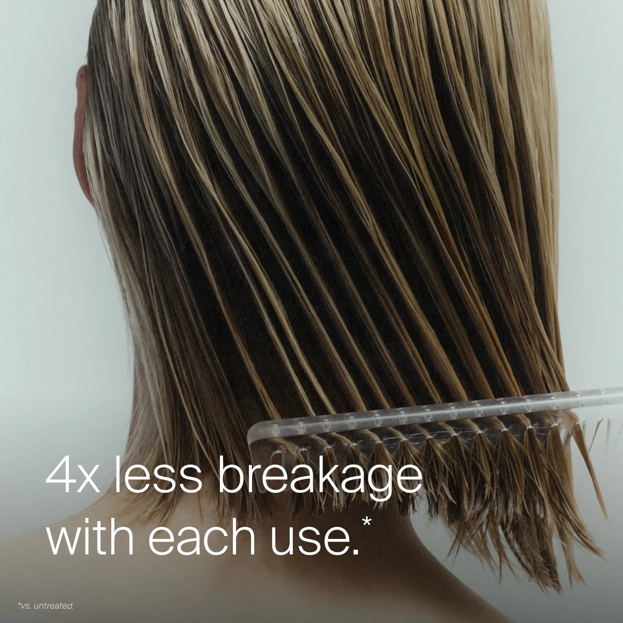 A person with wet, shoulder-length blonde hair uses a wide-tooth comb after applying Leave-In Conditioning Spray. Text reads: 4x less breakage and lasting detangling with each use.*.