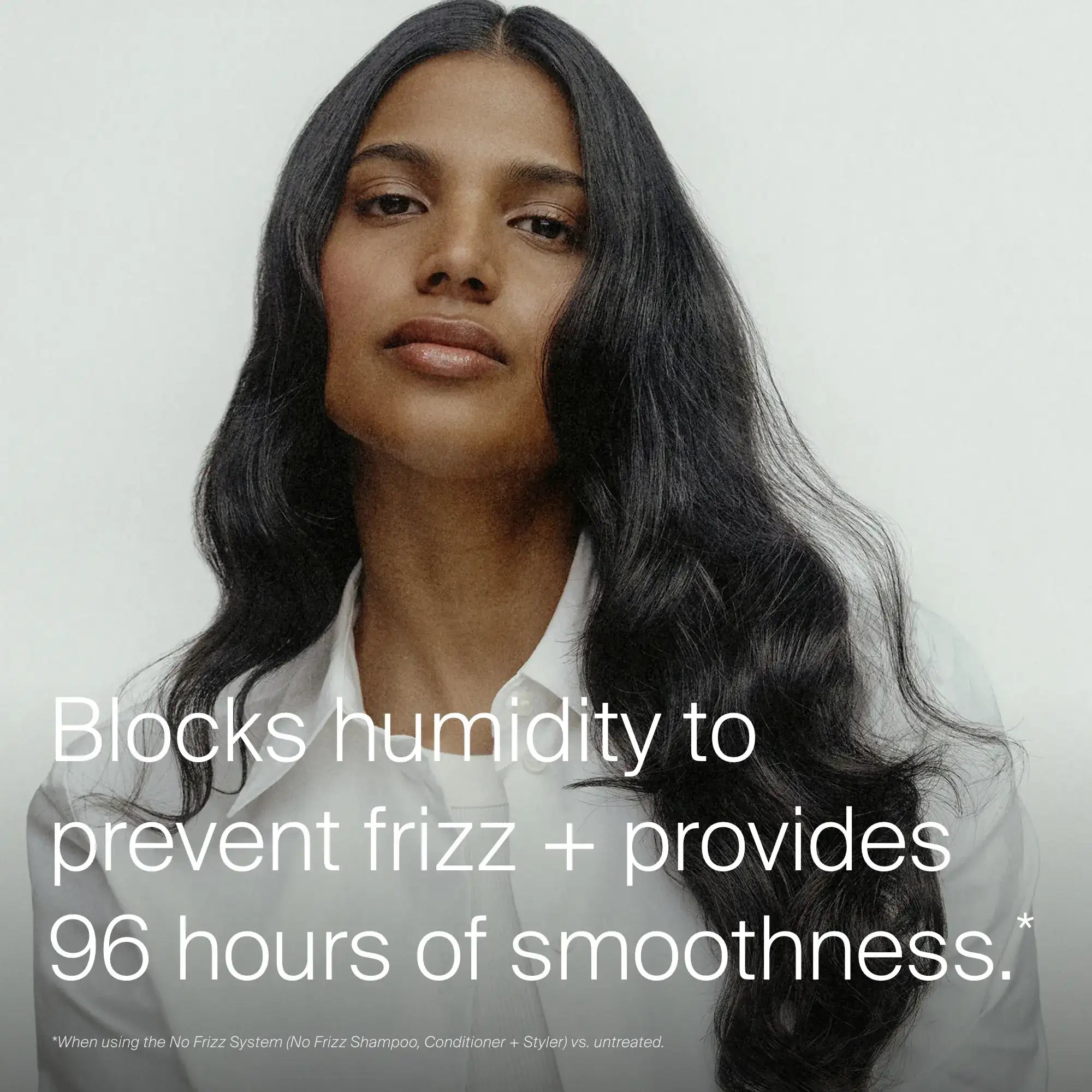 A woman with long, smooth, shiny black hair poses confidently. Text: No Frizz Smooth Styling Cream blocks humidity for frizz control & delivers 96 hours of smoothness. Ideal for medium hair. Fine print appears below.