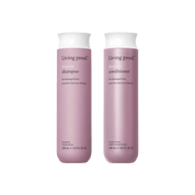 Two mauve bottles of Restore Wash Duo (236 mL each) with Sili-CLONE™ HairTech for damaged hair, standing upright against a white background.