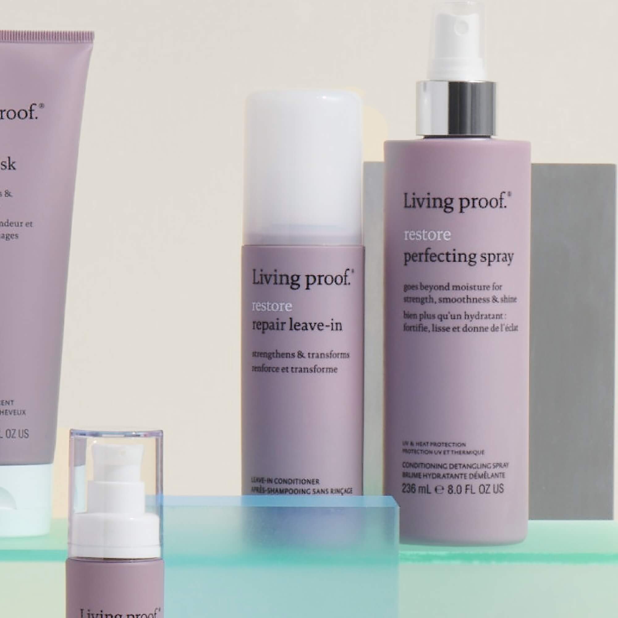 Living Proofs Restore Repair Leave-In, in a light purple bottle with white and black text, is displayed on a light surface. This haircare product is known for strengthening hair and reducing split ends.