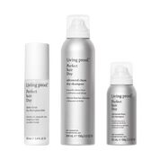Three silver and white bottles from the Living Proof Choose Your Clean Set—a sheer clean dry shampoo mist, an advanced clean dry shampoo, and a smaller dry shampoo—are displayed with simple, modern labels. Micellar-powered formulas help ensure clean hair without water for refreshed, revitalized style anytime.