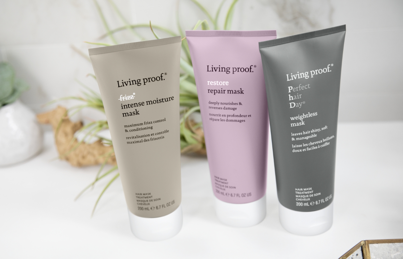 Three Living Proof haircare products.
