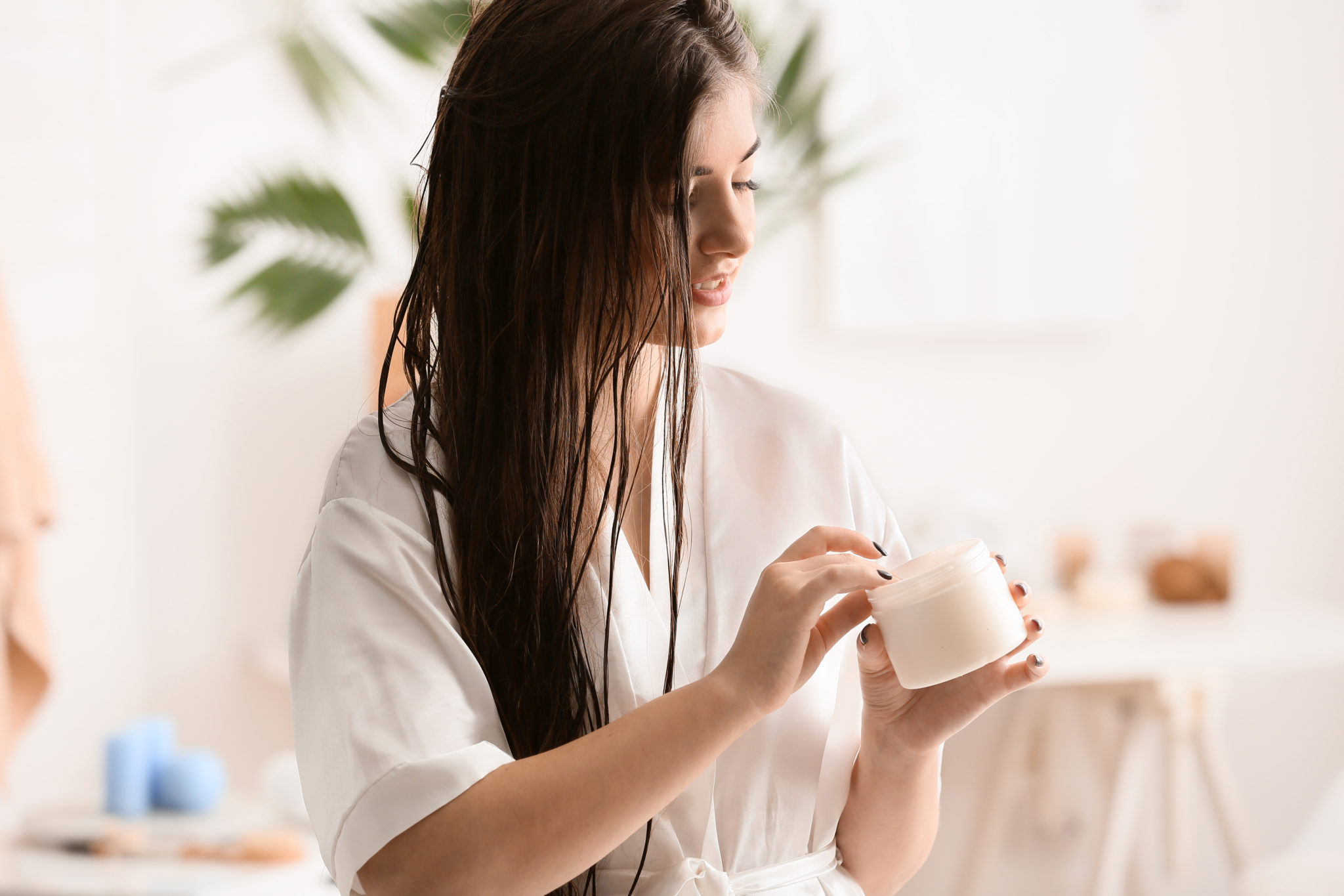 woman-scooping-leave-in-conditioner-into-her-hand