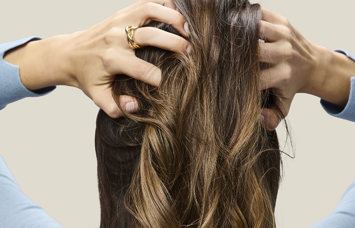 Woman with brown wavy hair.