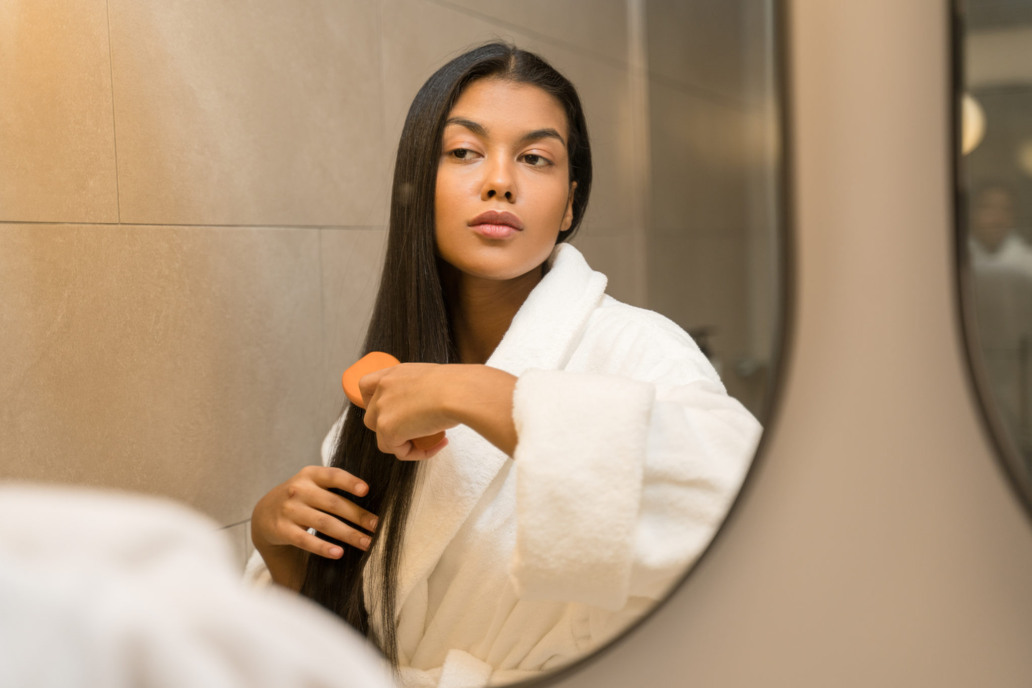 woman-in-a-robe-brushing-her-hair